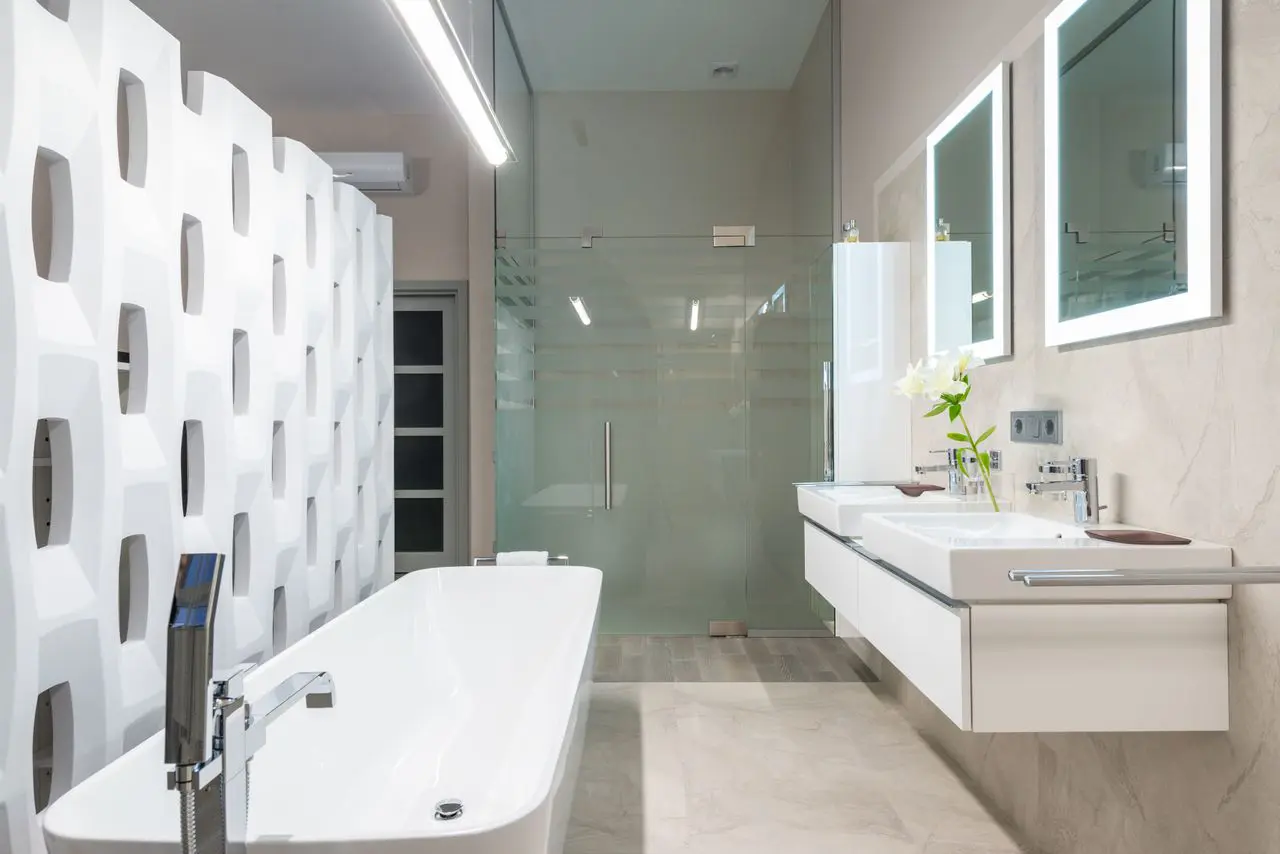 Frameless shower door, mirrors, and towel rail in a modern bathroom, Austin, TX