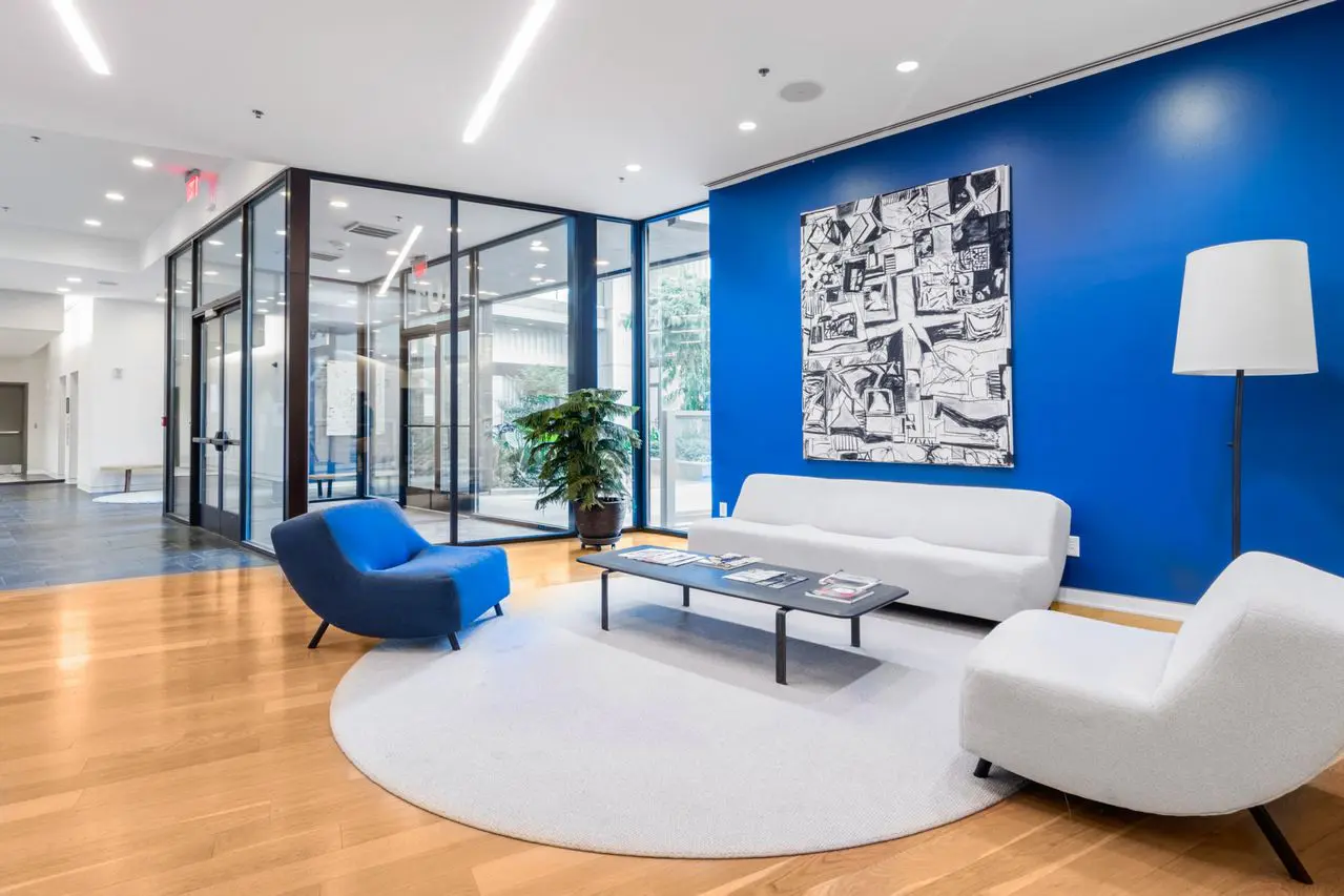 White wall base along an accent wall in a commercial lobby, Austin, TX