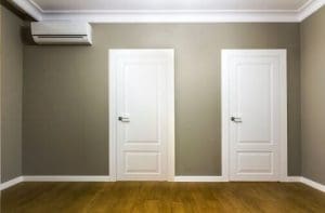 Comparison of a room in an apartment before and after renovation works. New house interior with plastered and painted walls, white doors and wooden oak floor. Real estate development concept.