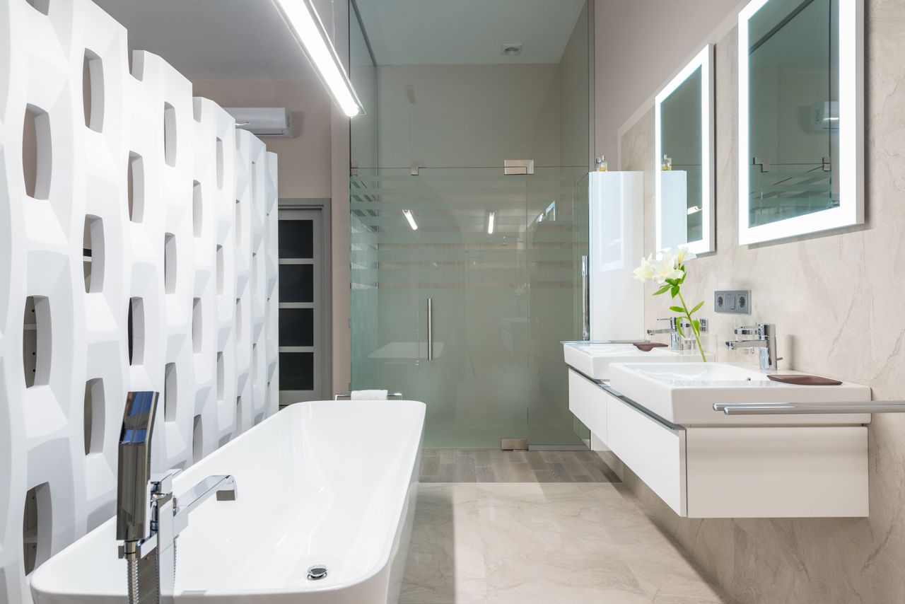 Frameless shower door, mirrors, and towel rail in a modern bathroom, Austin, TX